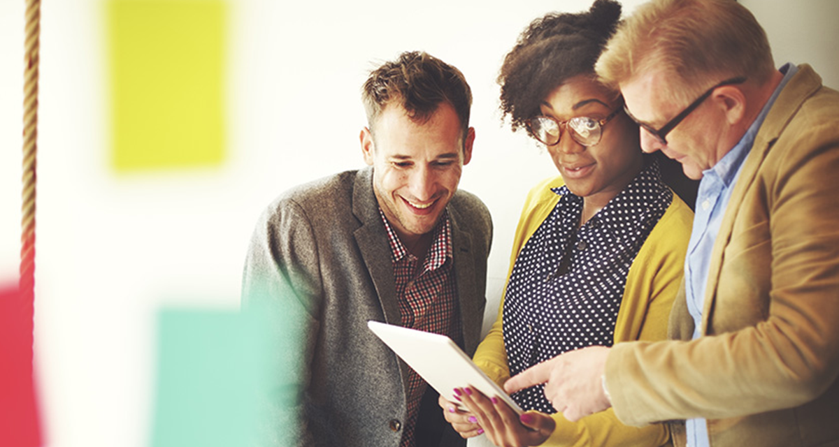 Three people reviewing a document